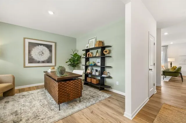a living room with furniture and wooden floor