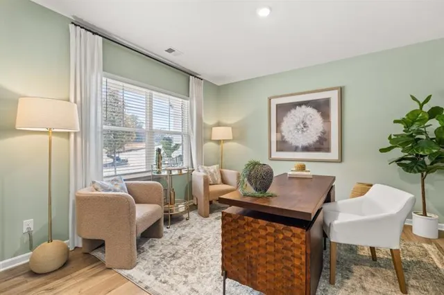 a living room with furniture and a potted plant