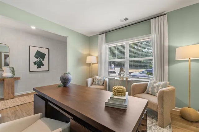 a view of a dining room with furniture and a large window
