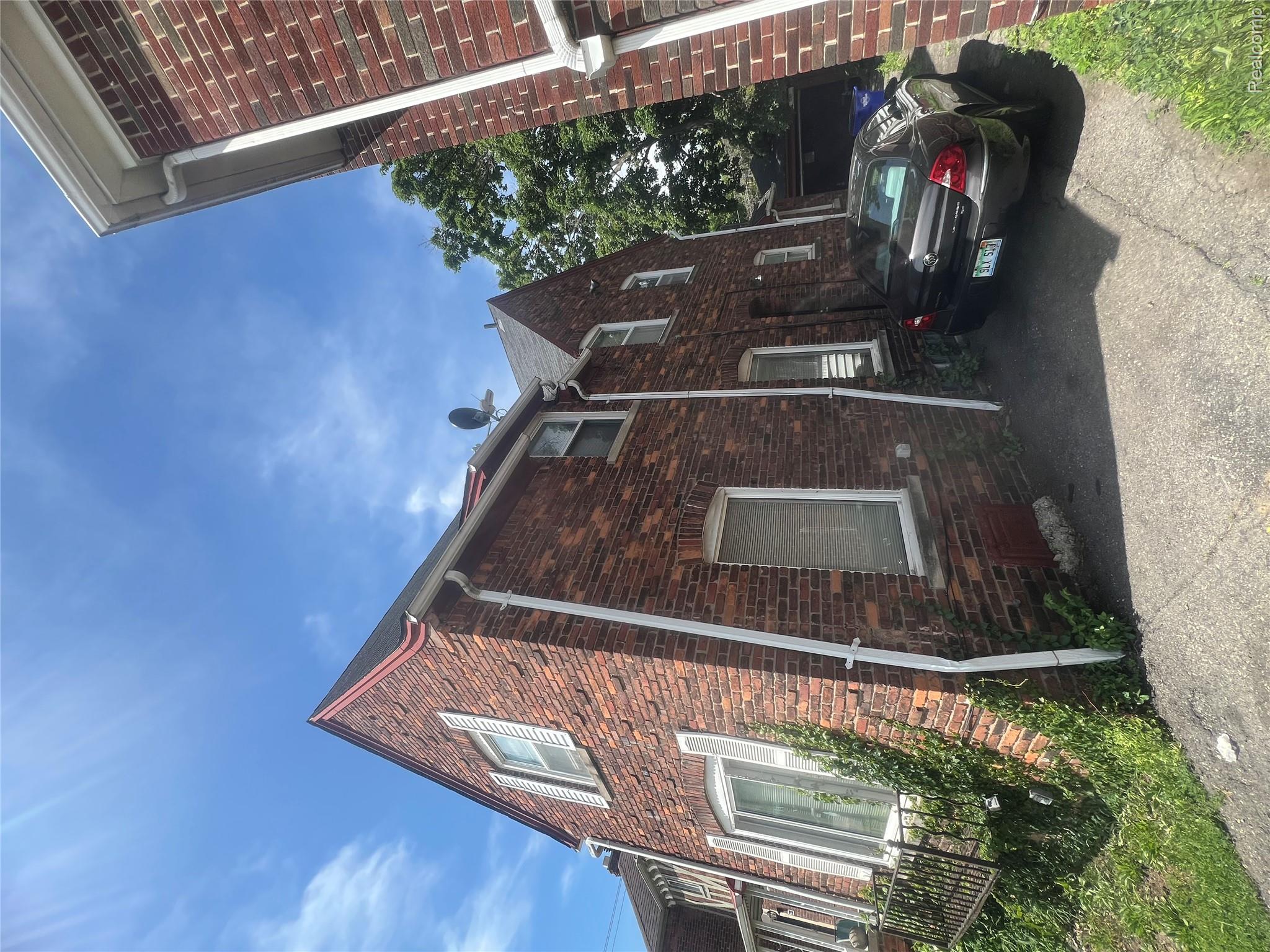 17311 Santa Rosa Drive Detroit, MI 48221 - Photo 9 of 89 Brick exterior with white window frames and louvered shutters