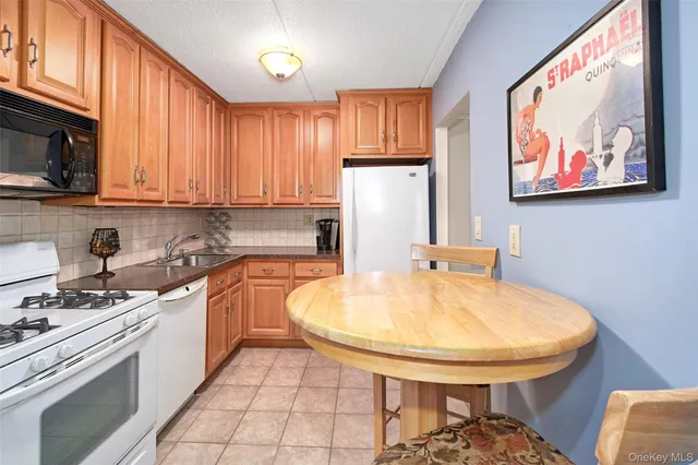 a kitchen with stainless steel appliances a stove a sink and a microwave