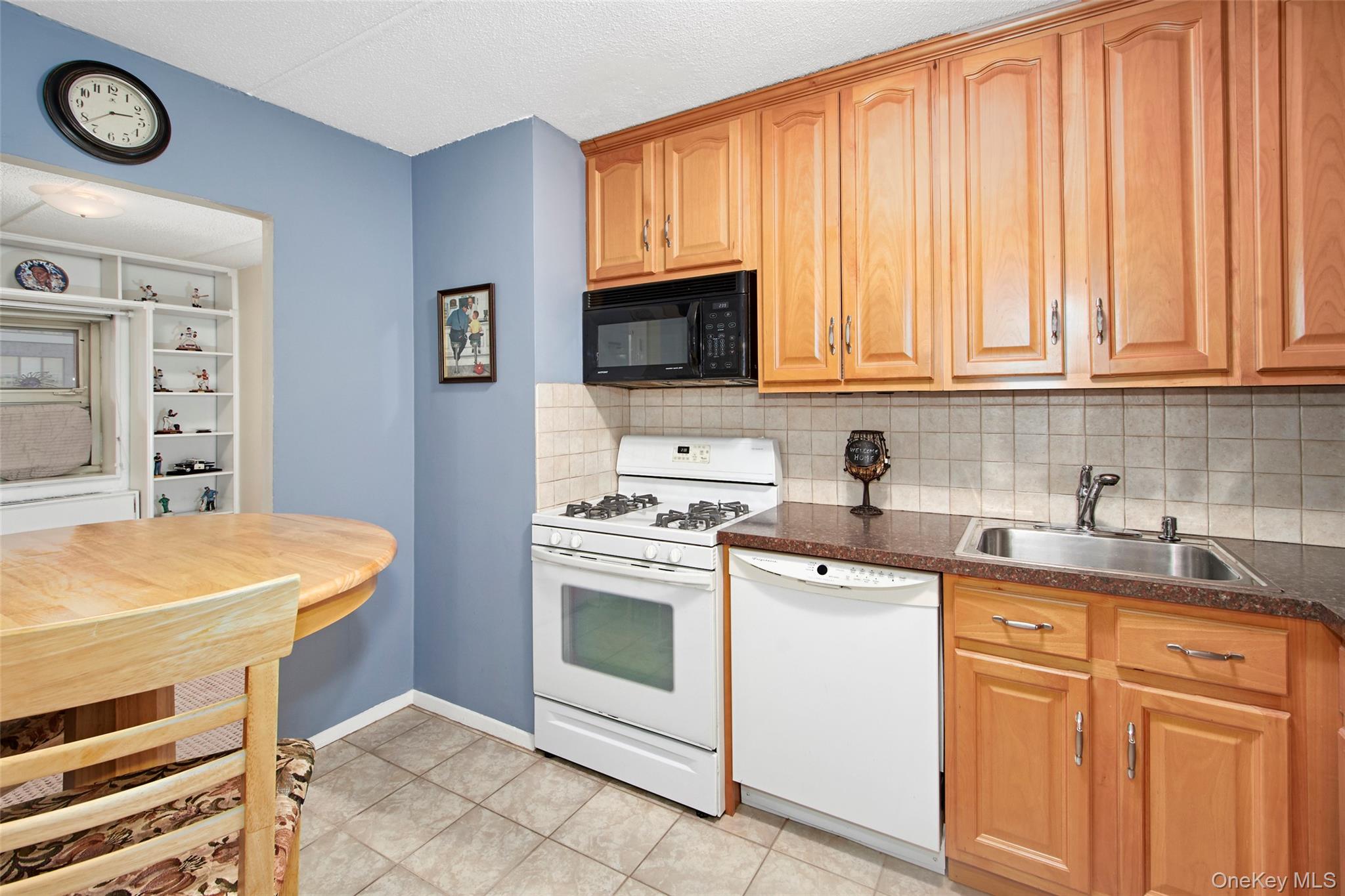 470 Halstead Avenue, Unit 2T Harrison, NY 10528 - Photo 15 of 23 a kitchen with stainless steel appliances granite countertop a stove a sink dishwasher and a microwave oven with white cabinets