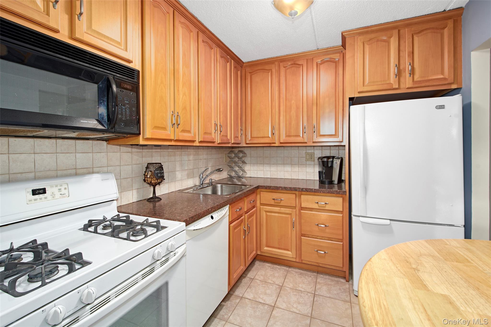 470 Halstead Avenue, Unit 2T Harrison, NY 10528 - Photo 16 of 23 a kitchen with stainless steel appliances granite countertop a stove a sink and a refrigerator