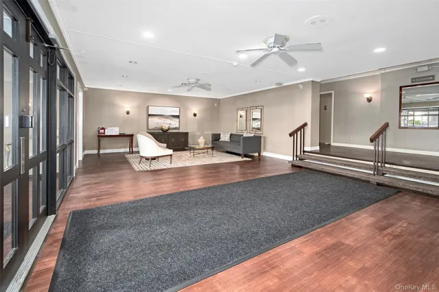 a view of living room with furniture and a ceiling fan