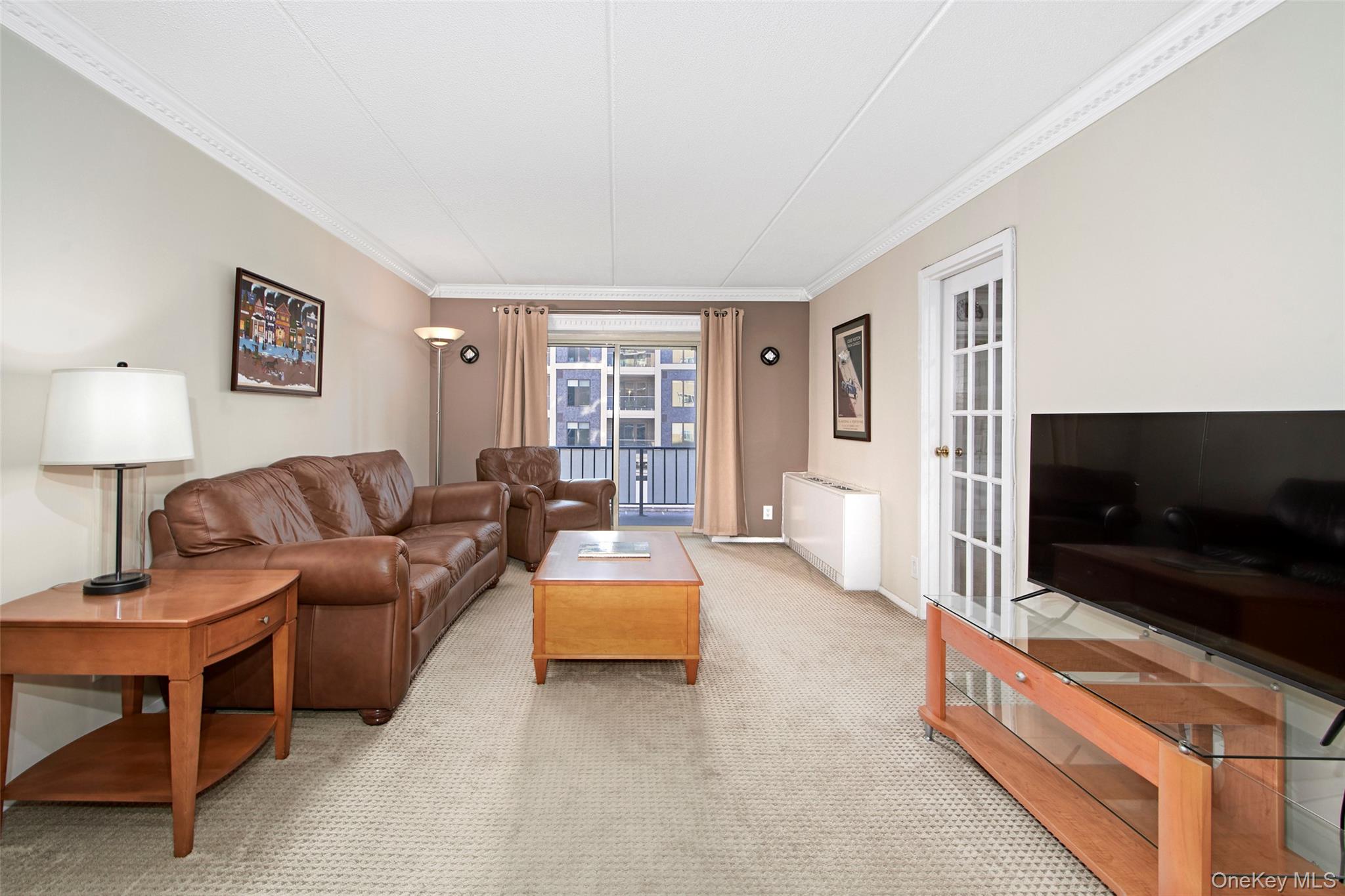 470 Halstead Avenue, Unit 2T Harrison, NY 10528 - Photo 7 of 23 a living room with furniture and a flat screen tv