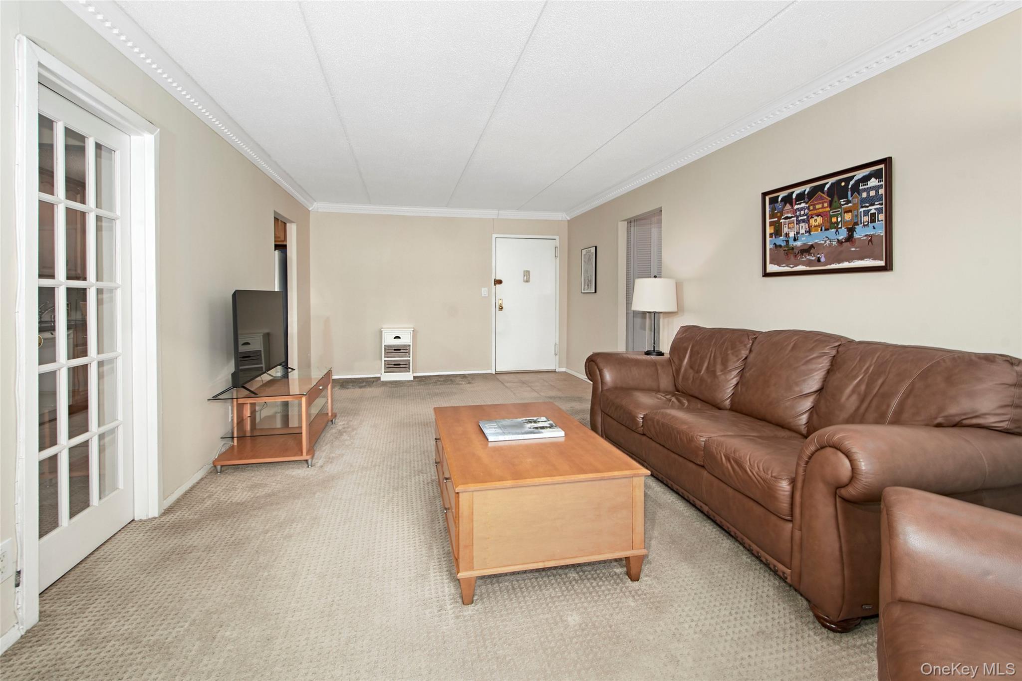 470 Halstead Avenue, Unit 2T Harrison, NY 10528 - Photo 9 of 23 a living room with furniture and a flat screen tv