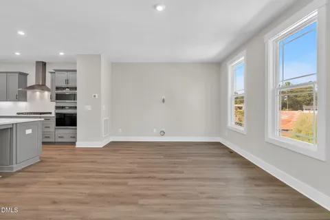 a view of a room with wooden floors and stairs