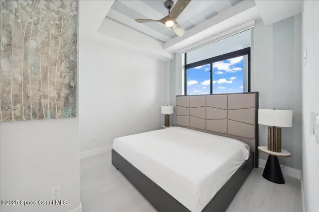 a bedroom with a bed and a lamp