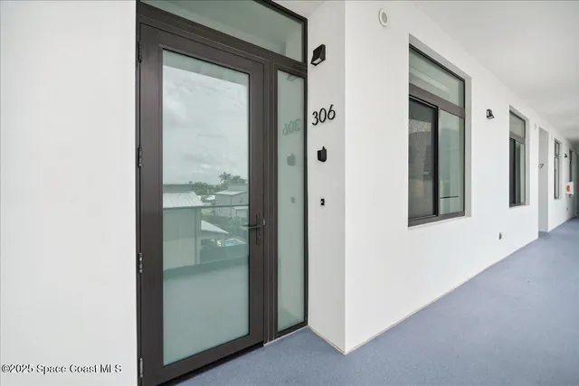 a roof deck with couch and a potted plant