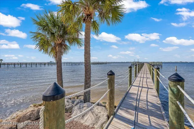 a view of a large building with a yard and plants