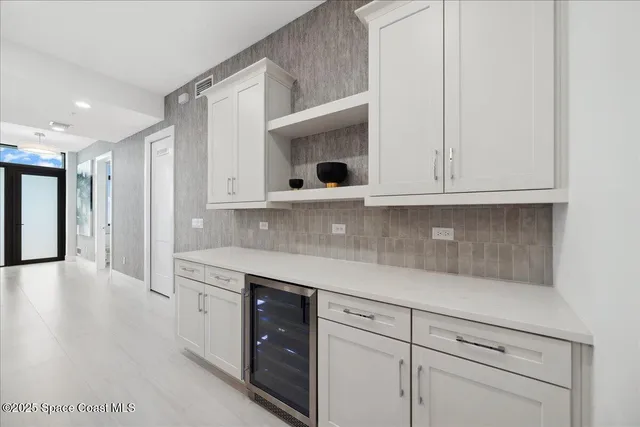 a view of a dining room with furniture large windows and wooden floor
