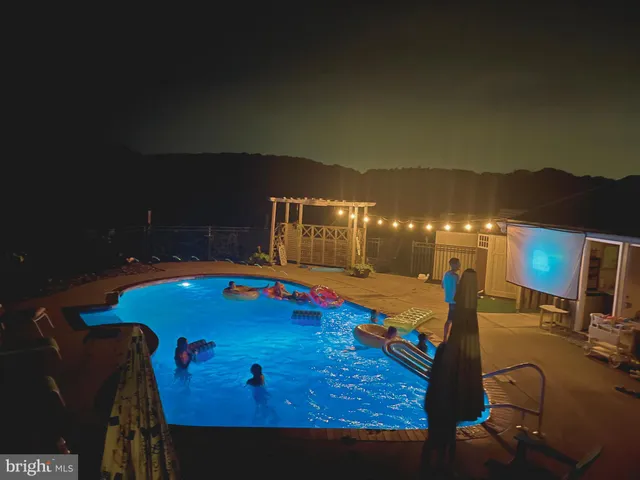 a room with pool table and chairs