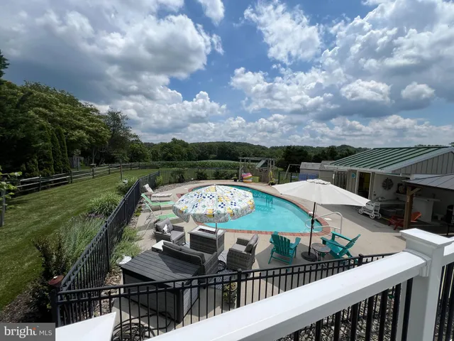 a view of a swimming pool and deck