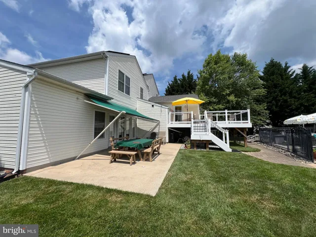 a car parked in front of a house with wooden fence