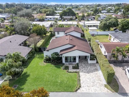 an aerial view of a house with garden space and lake view