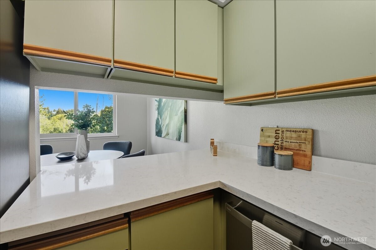 18150 73rd Avenue Northeast, Unit B306 Kenmore, WA 98028 - Photo 11 of 32 a kitchen with a sink and cabinets