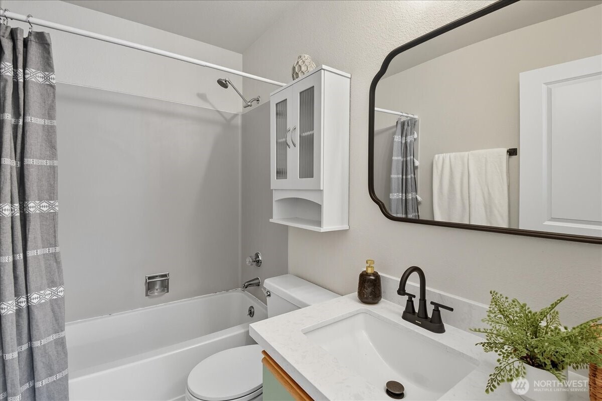 18150 73rd Avenue Northeast, Unit B306 Kenmore, WA 98028 - Photo 16 of 32 a bathroom with a sink toilet and shower