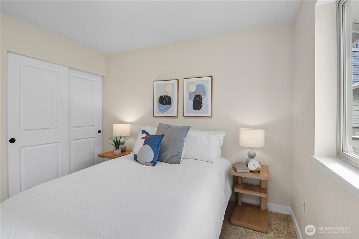 18150 73rd Avenue Northeast, Unit B306 Kenmore, WA 98028 - Photo 18 of 32 a bedroom with a bed and night stand