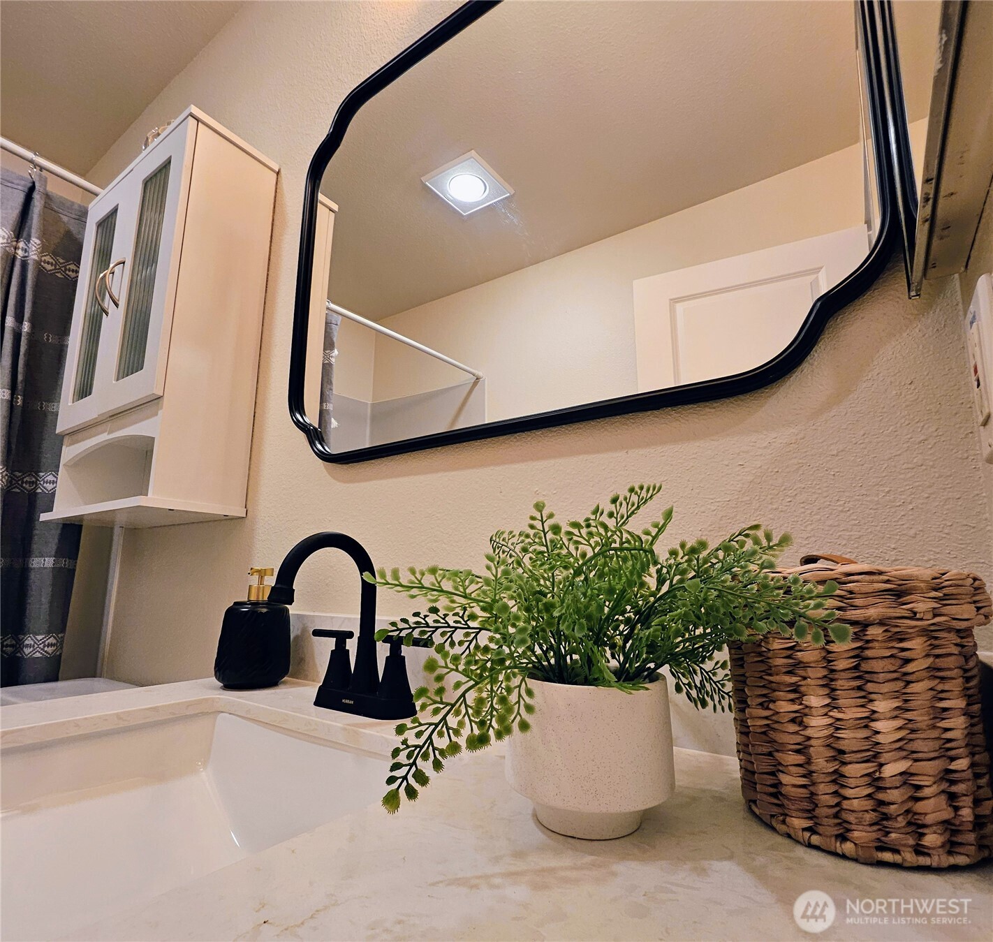 18150 73rd Avenue Northeast, Unit B306 Kenmore, WA 98028 - Photo 27 of 32 a close view of sink and mirror
