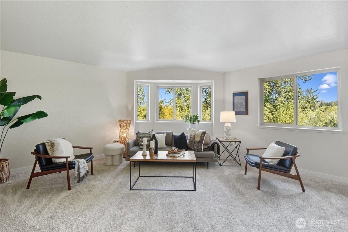 18150 73rd Avenue Northeast, Unit B306 Kenmore, WA 98028 - Photo 5 of 32 a living room with furniture and a potted plant