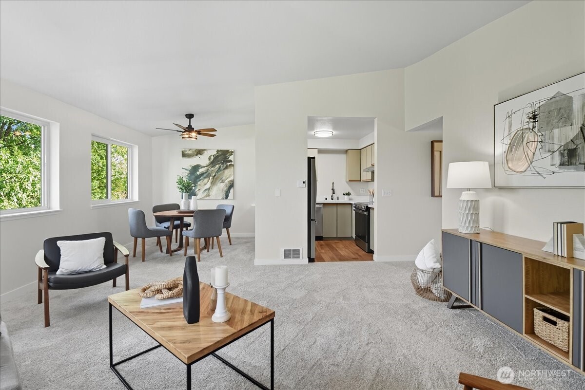 18150 73rd Avenue Northeast, Unit B306 Kenmore, WA 98028 - Photo 6 of 32 a living room with furniture and a table