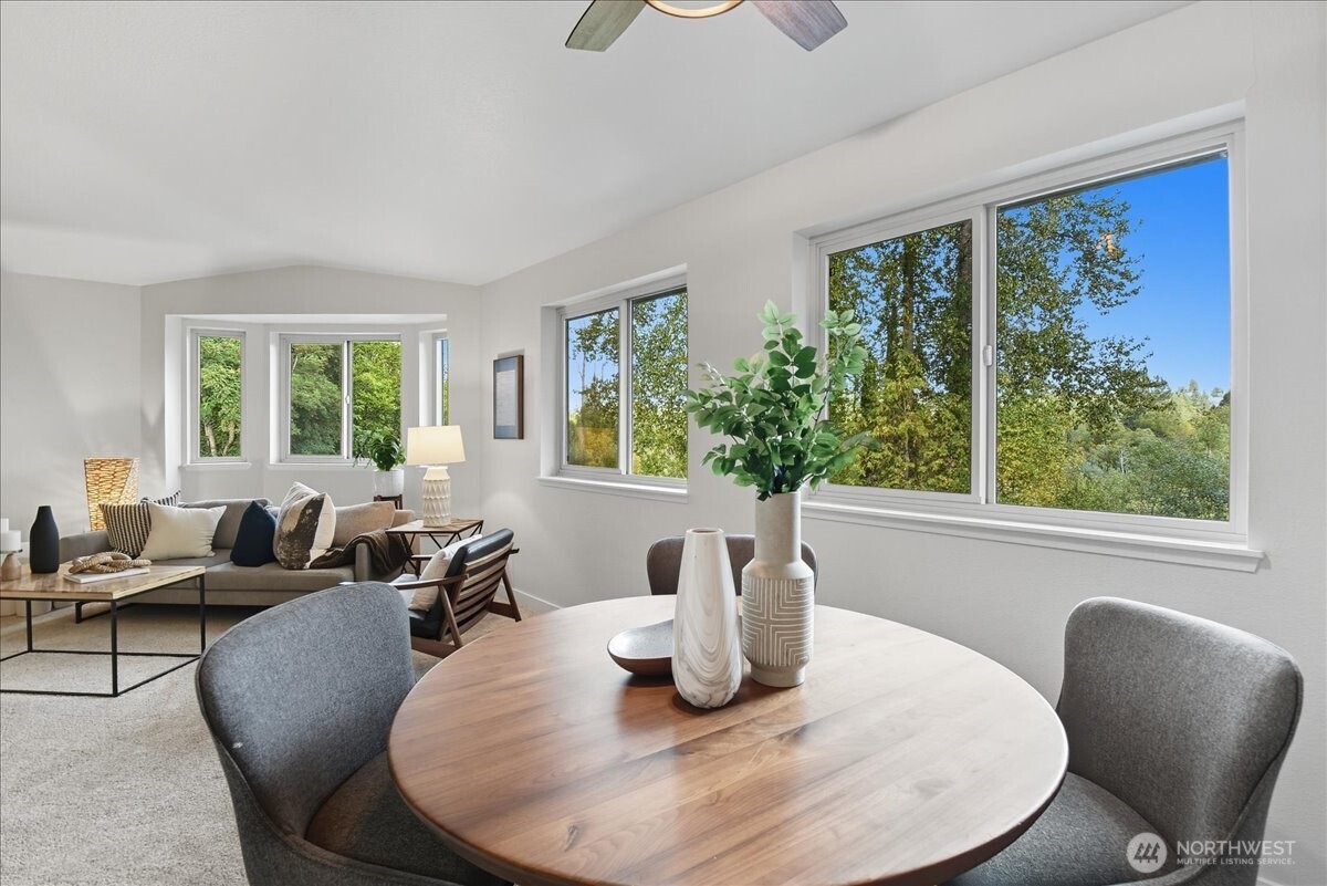 18150 73rd Avenue Northeast, Unit B306 Kenmore, WA 98028 - Photo 7 of 32 a living room with furniture and a large window