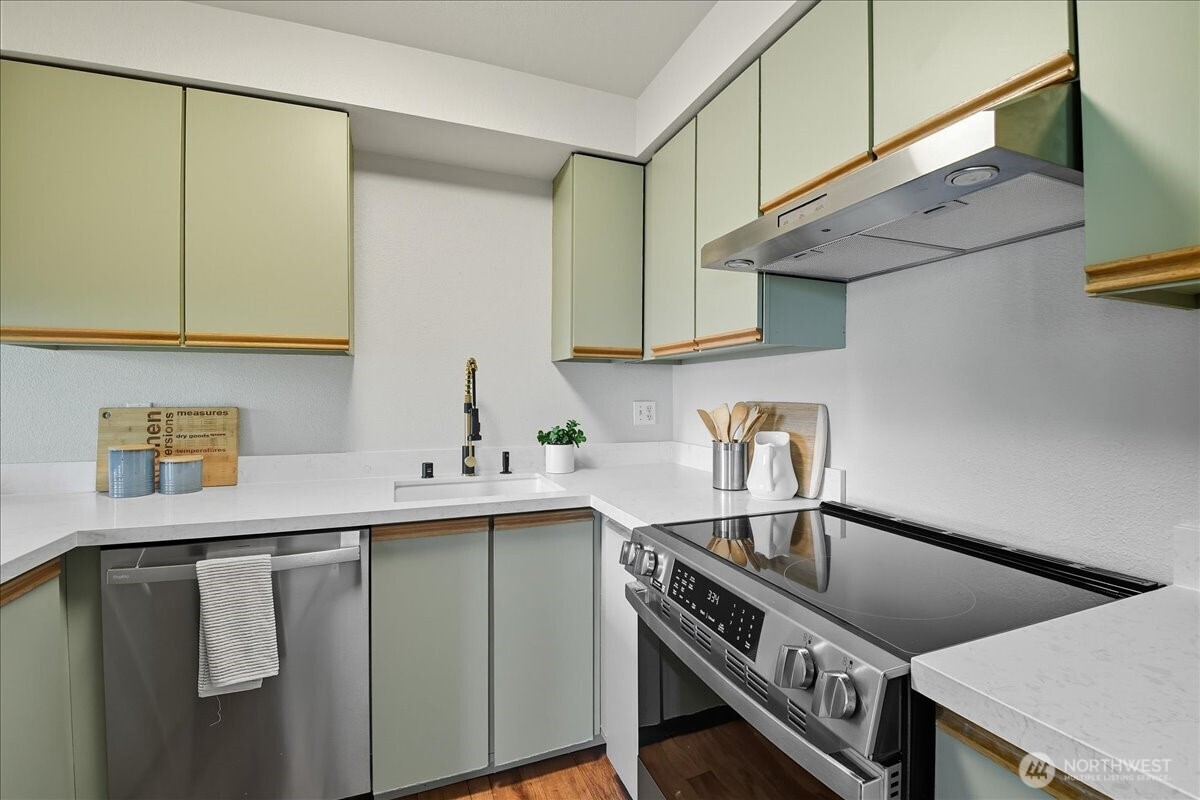 18150 73rd Avenue Northeast, Unit B306 Kenmore, WA 98028 - Photo 10 of 32 a kitchen with a sink a stove and cabinets