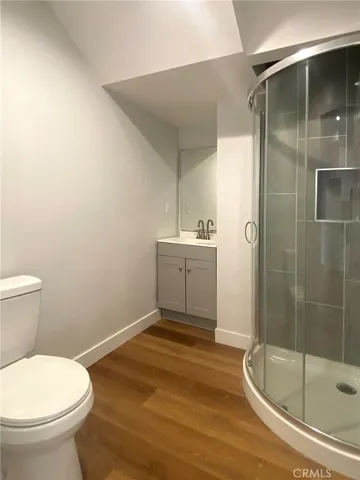 a bathroom with a toilet and a shower