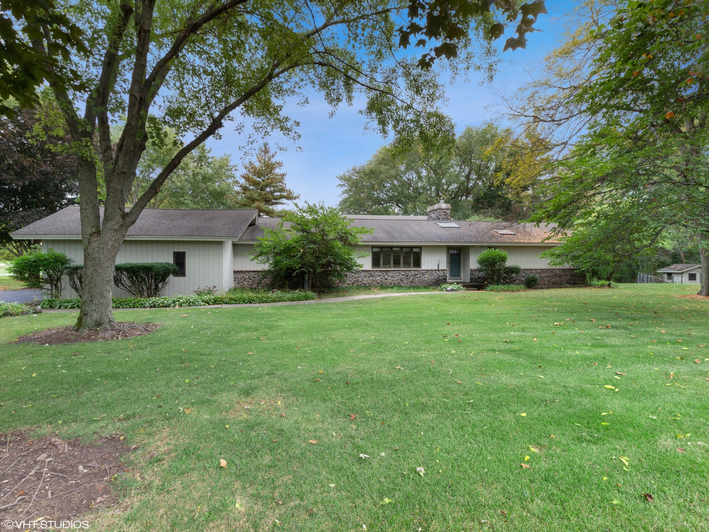 67 Round Barn Road Barrington Hills, IL 60010 - Photo 1 of 43 a front view of a house with a yard and trees