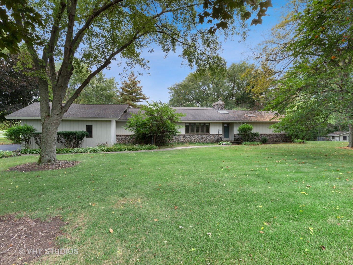 67 Round Barn Road Barrington Hills, IL 60010 - Photo 2 of 43 a front view of a house with a yard and trees