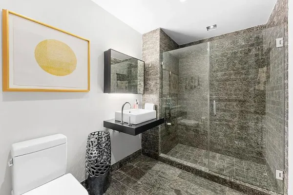 a bathroom with a toilet sink and shower