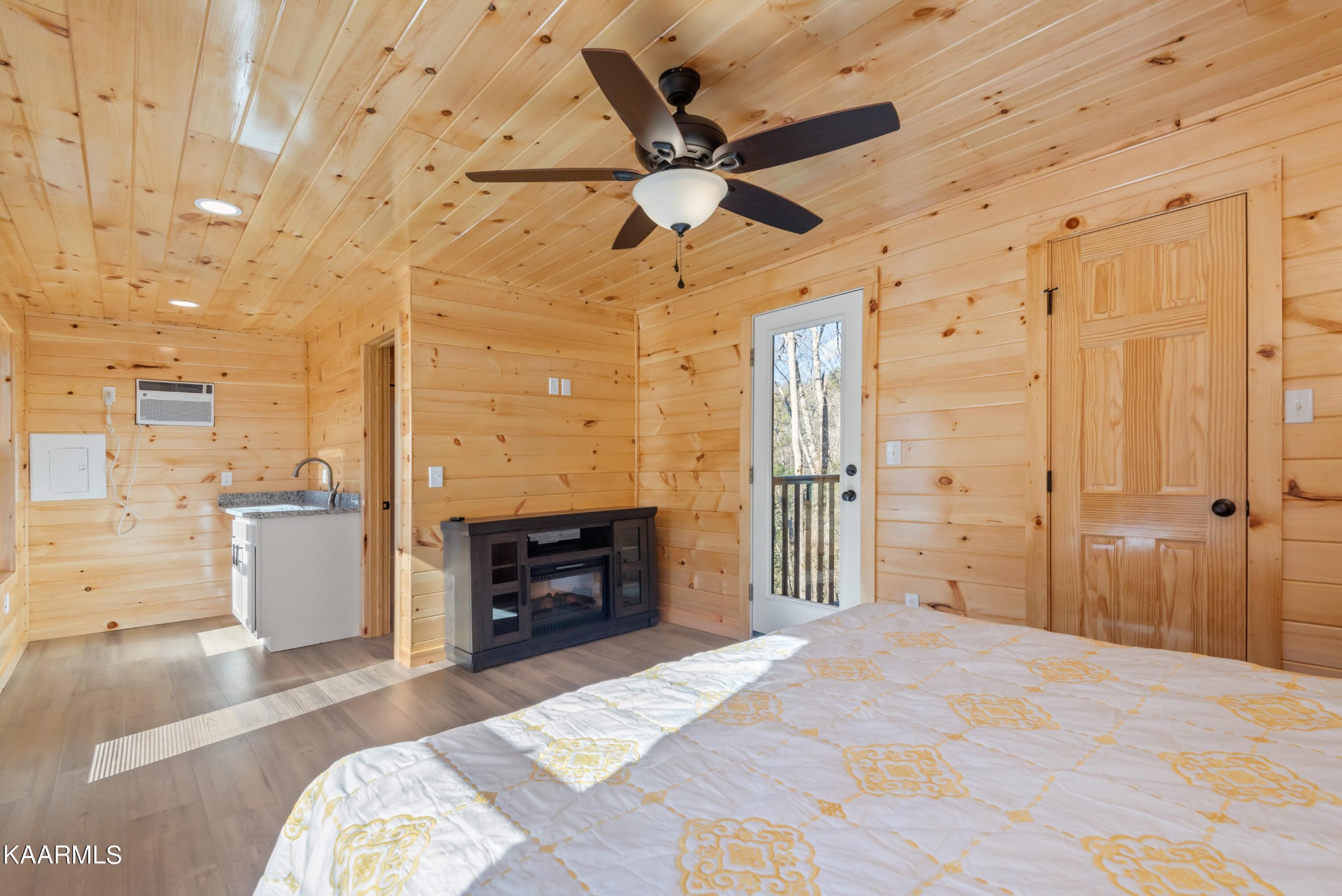 306 Glades Road Gatlinburg, TN 37738 - Photo 13 of 46 a bedroom with a bed and a chandelier