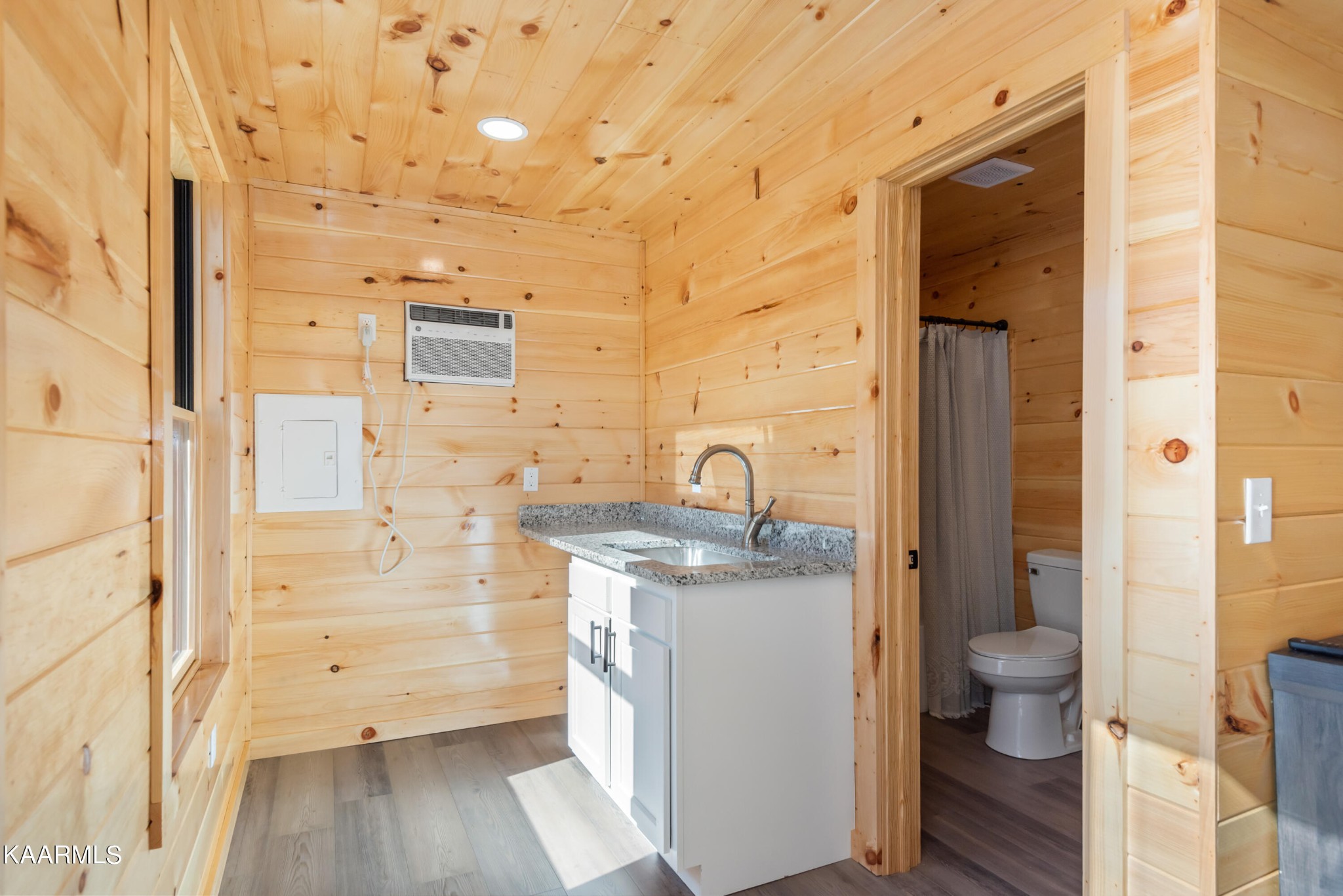 306 Glades Road Gatlinburg, TN 37738 - Photo 14 of 46 a bathroom with a granite countertop sink toilet and shower