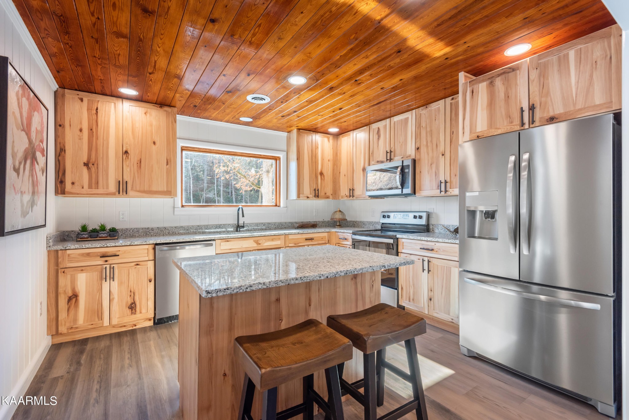 306 Glades Road Gatlinburg, TN 37738 - Photo 26 of 46 a kitchen with stainless steel appliances granite countertop a refrigerator a sink dishwasher a stove and white countertops with wooden floor
