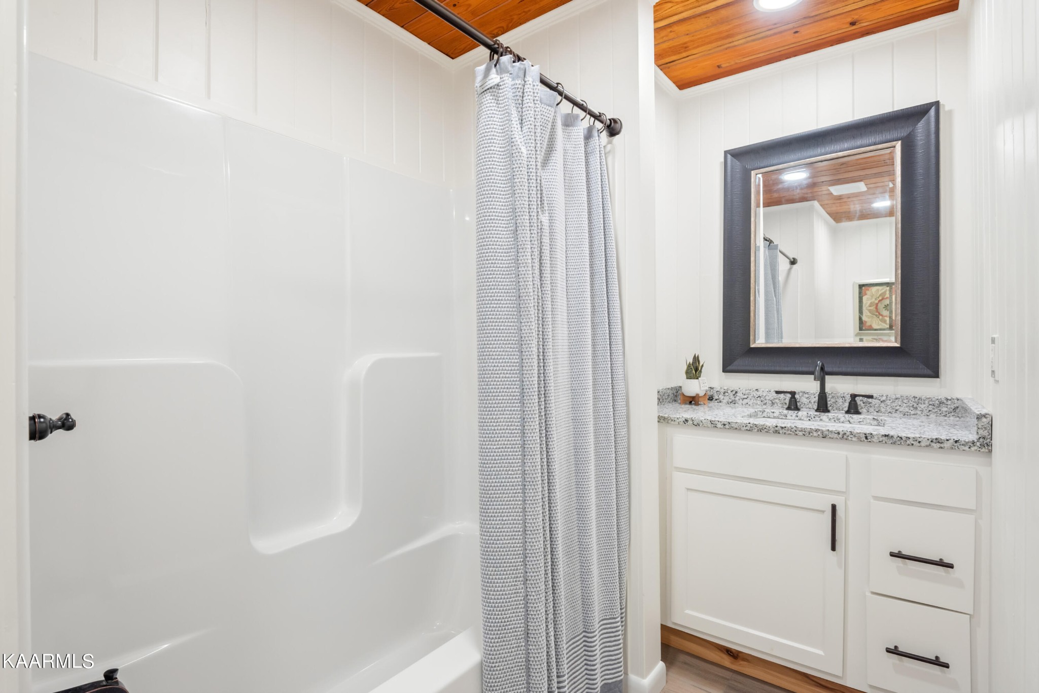 306 Glades Road Gatlinburg, TN 37738 - Photo 37 of 46 a bathroom with a granite countertop sink a mirror and a bathtub