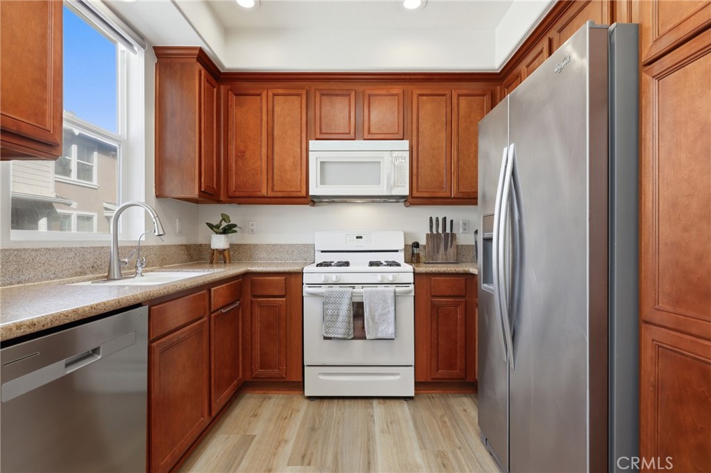 52 Valmont Way Ladera Ranch, CA 92694 - Photo 7 of 29 a kitchen with stainless steel appliances granite countertop a refrigerator and a sink
