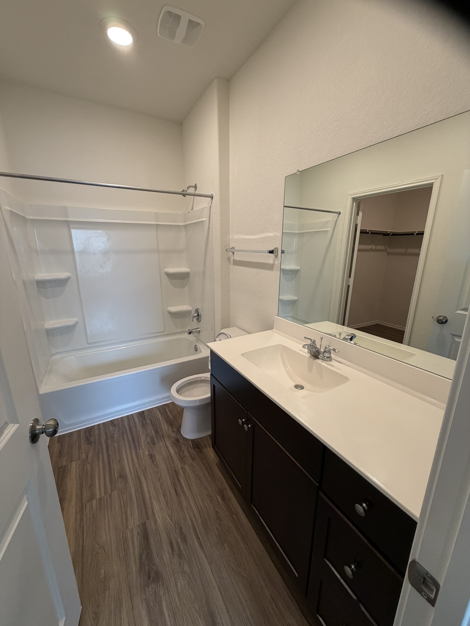 408 Buckners Street Georgetown, TX 78626 - Photo 11 of 15 a bathroom with a sink a toilet a mirror and vanity