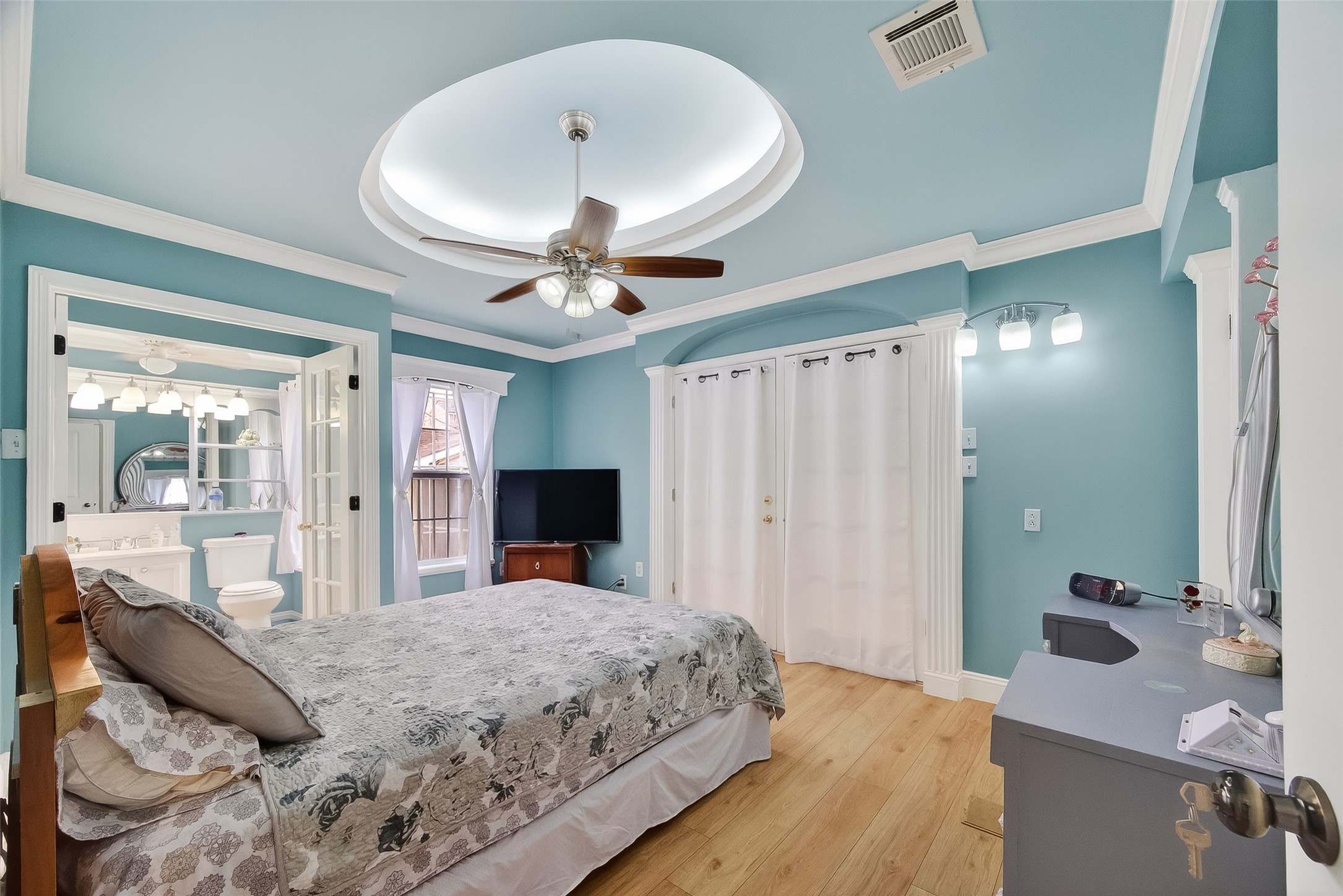 7404 Erath Street Houston, TX 77023 - Photo 11 of 40 a bedroom with a large bed and a chandelier