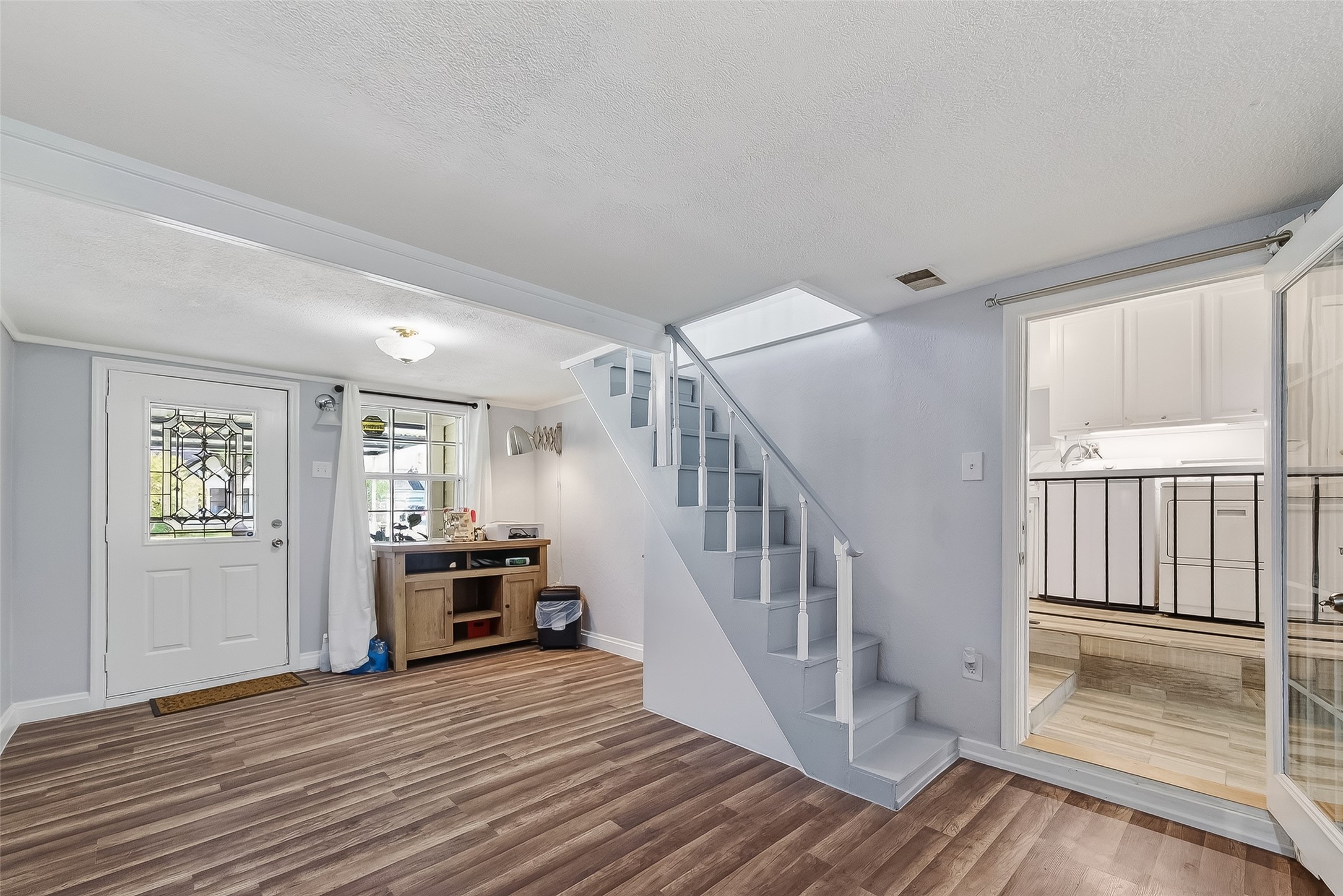 7404 Erath Street Houston, TX 77023 - Photo 16 of 40 a view of a livingroom with wooden floor and stairs