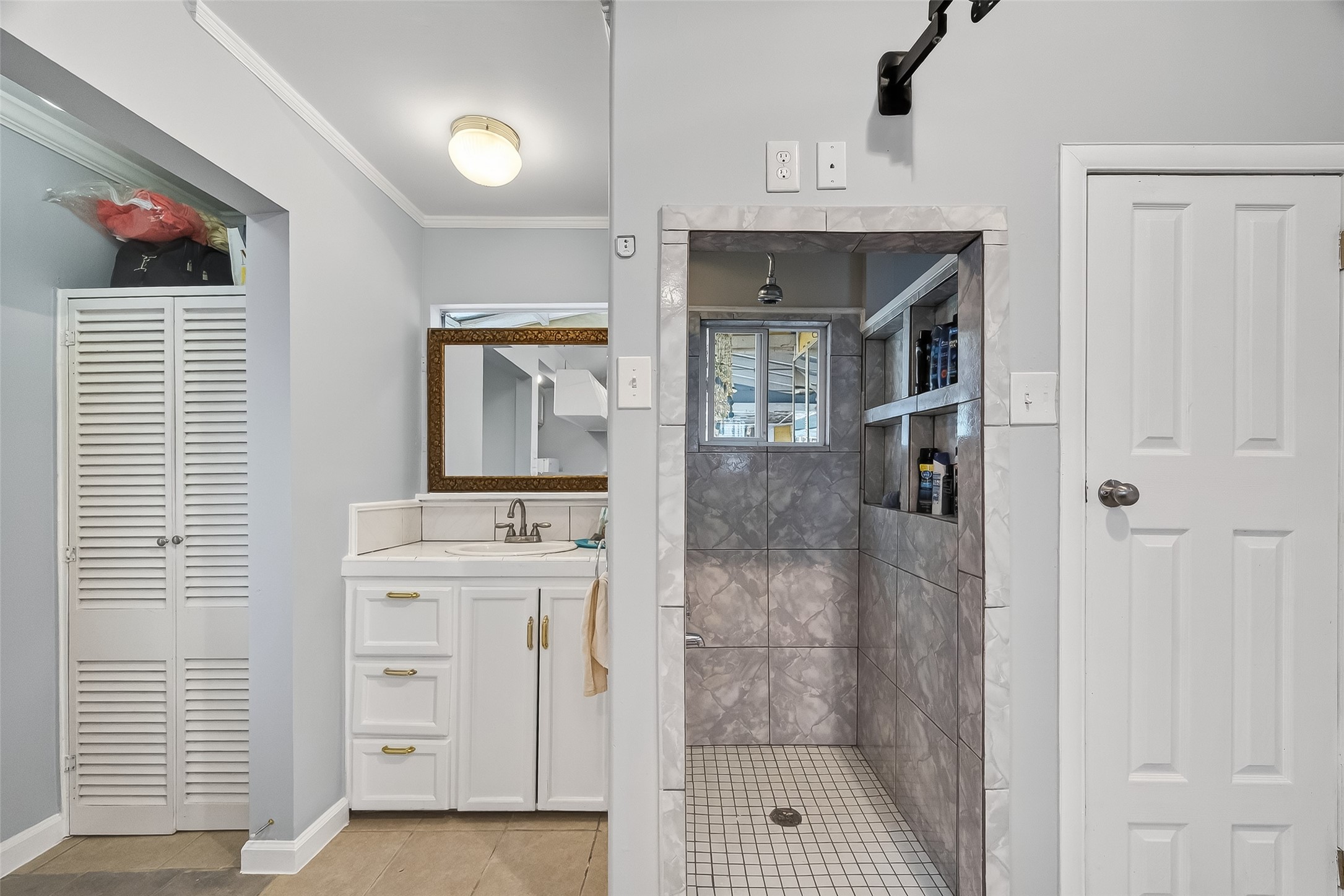 7404 Erath Street Houston, TX 77023 - Photo 29 of 40 a bathroom with a sink a mirror and shower
