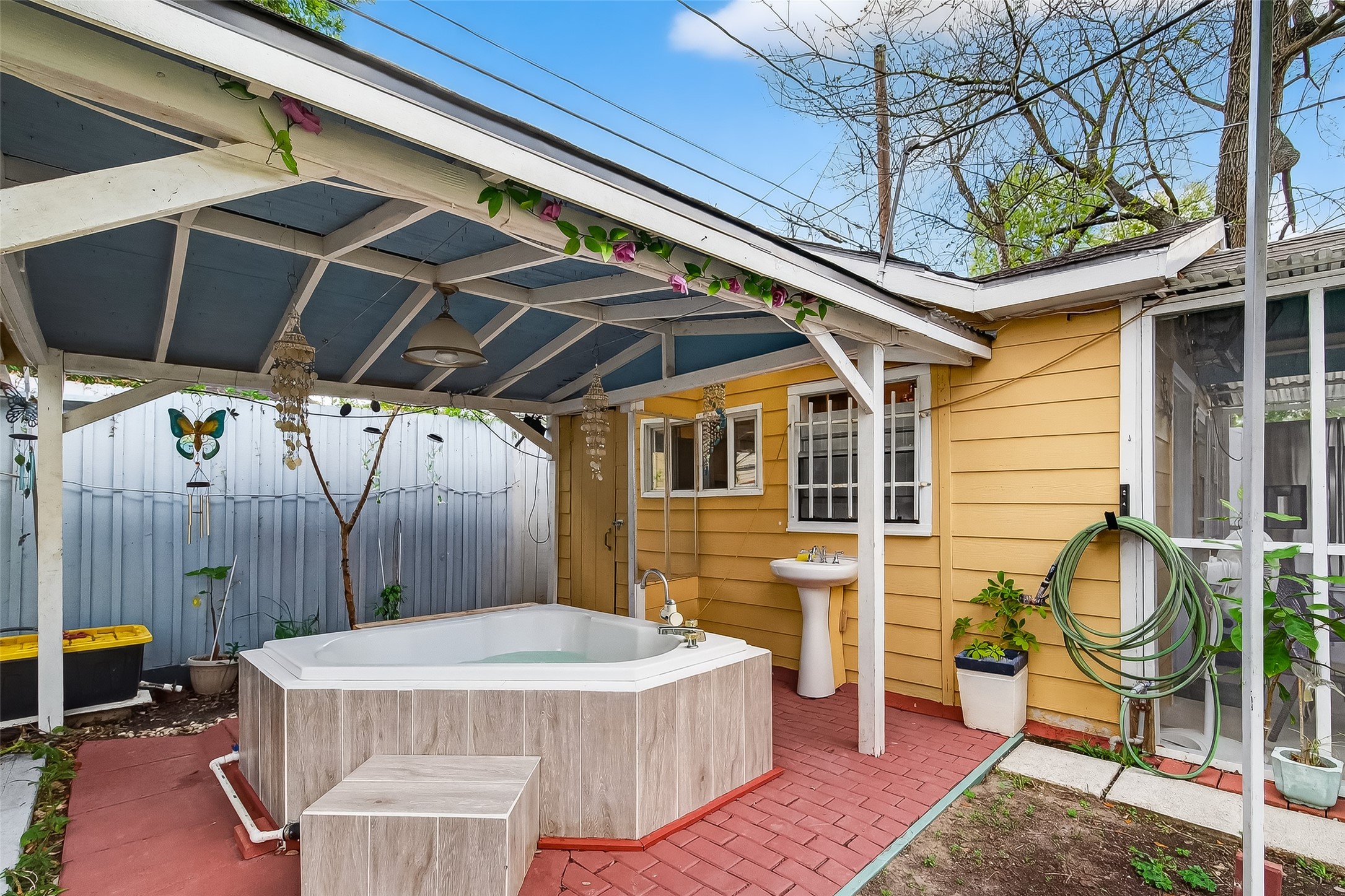 7404 Erath Street Houston, TX 77023 - Photo 30 of 40 a view of a patio with table and chairs with wooden floor and fence