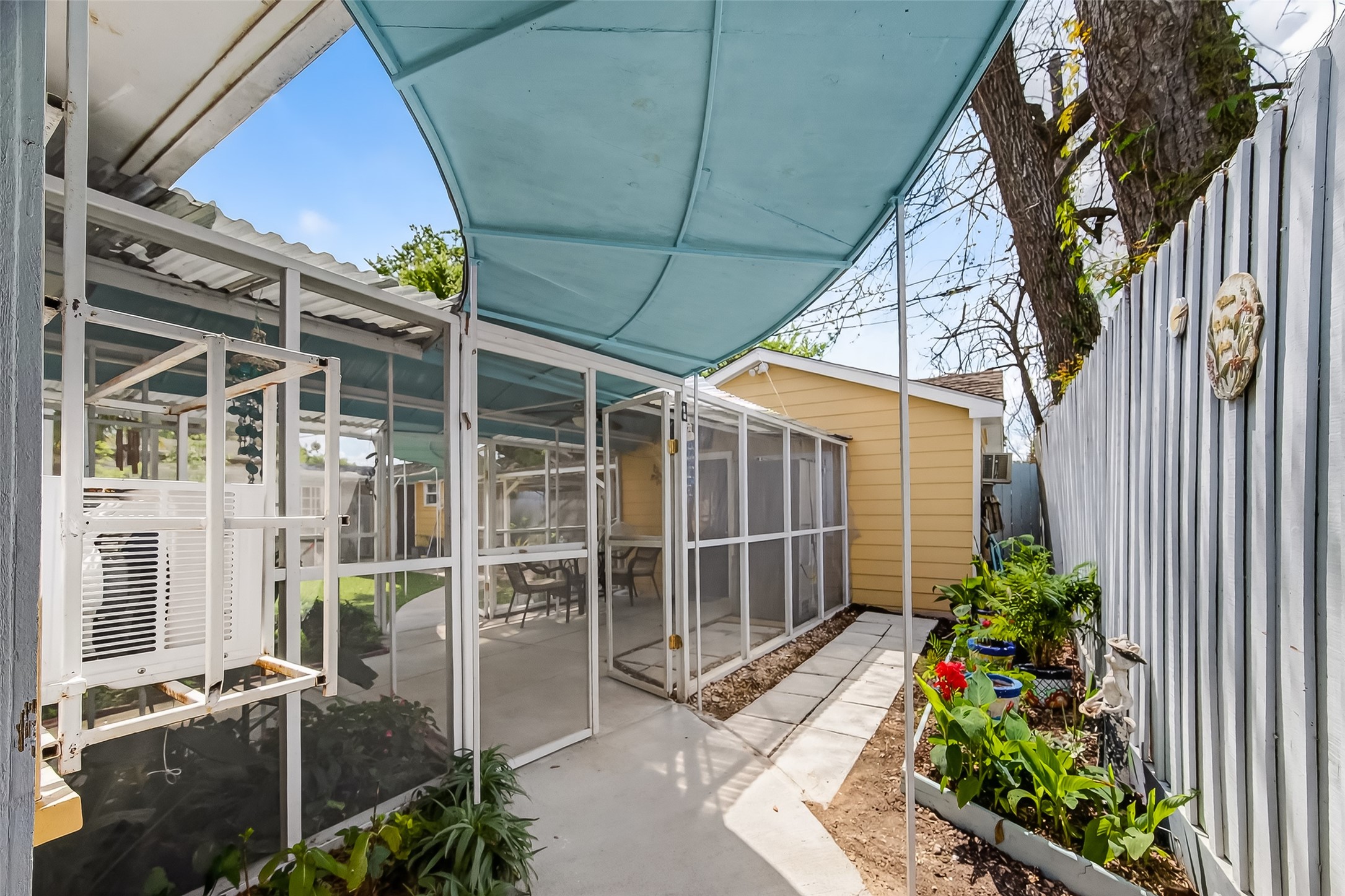 7404 Erath Street Houston, TX 77023 - Photo 36 of 40 a view of a house with a potted plant and floor to ceiling window and potted plants