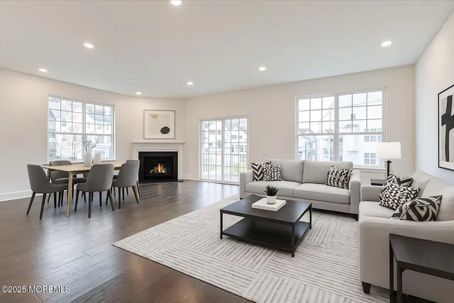 a living room with furniture wooden floor and a fireplace