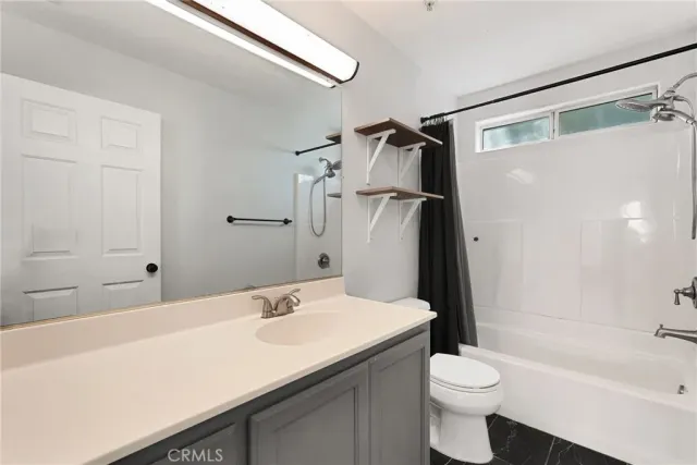 a spacious bedroom with a bed and wooden floor