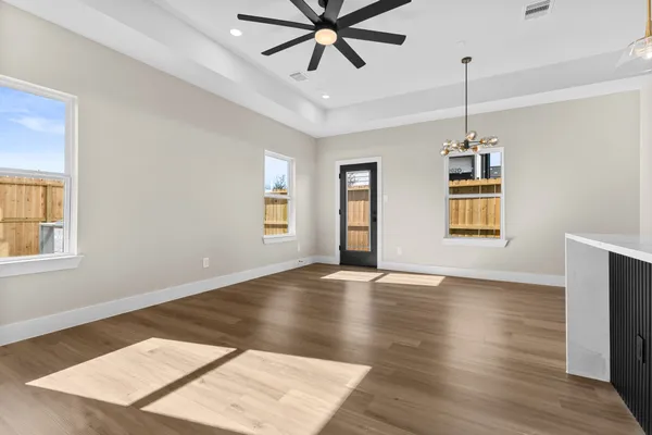 a view of a hallway with wooden floor and closet