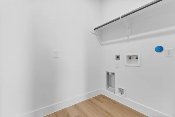 a bathroom with a sink a toilet a mirror and shower