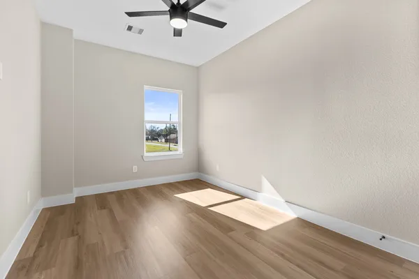 wooden floor in an empty room with a window