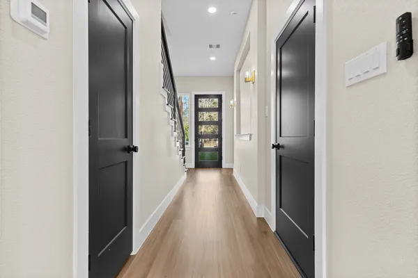 a view of hallway with wooden floor