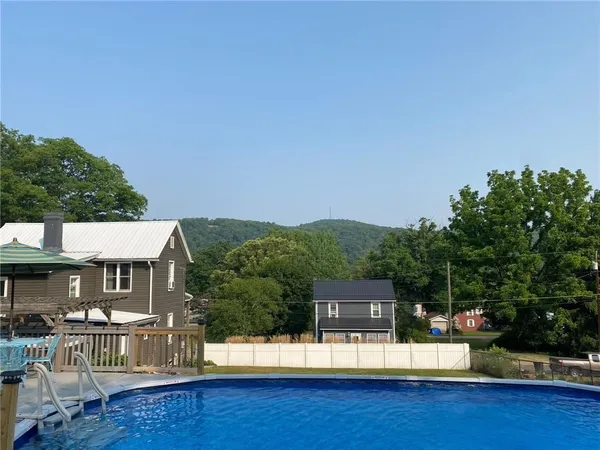 a view of a patio with table and chairs potted plants with swimming pool