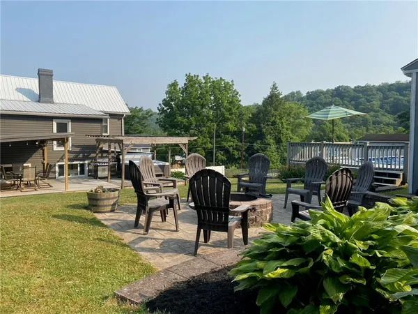 a view of house with roof deck and seating space